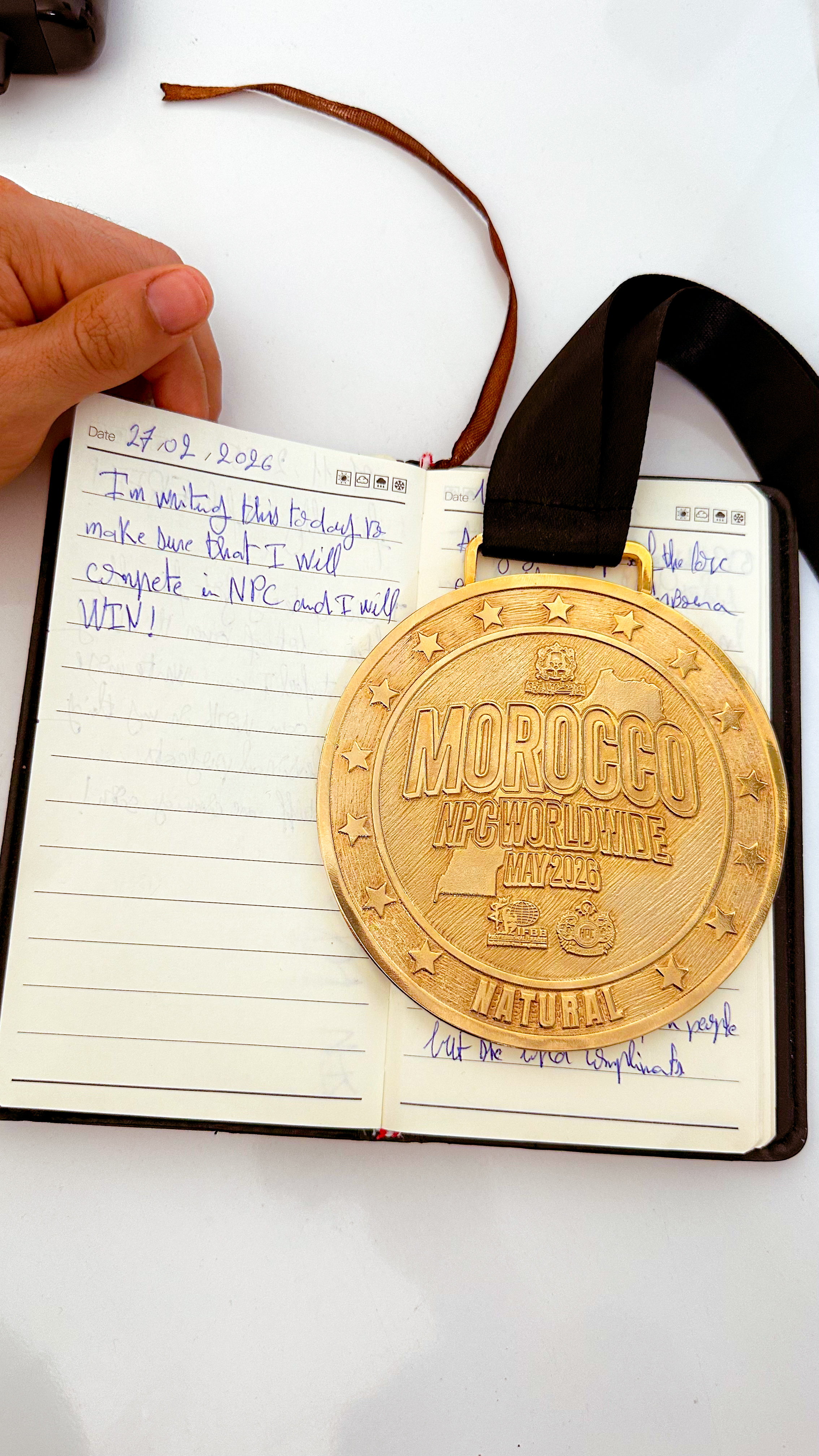 Handwritten note written by Mehdi Seyrini before the competition: I will compete and I will win, with a medal